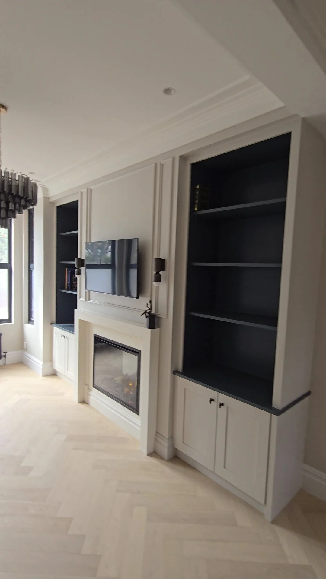 Media wall with string architectural features built by signature joinery and construction