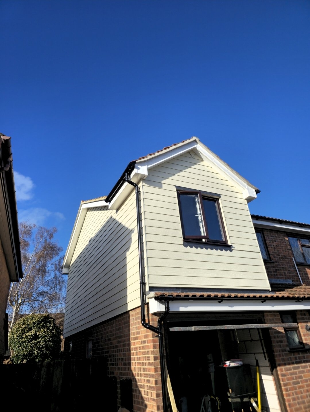 timber frame extension covered in a cream Hardie plank cladding
