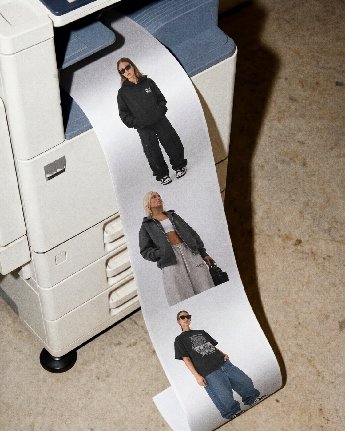 Printout of three models showcasing casual streetwear, coming out of a printer.