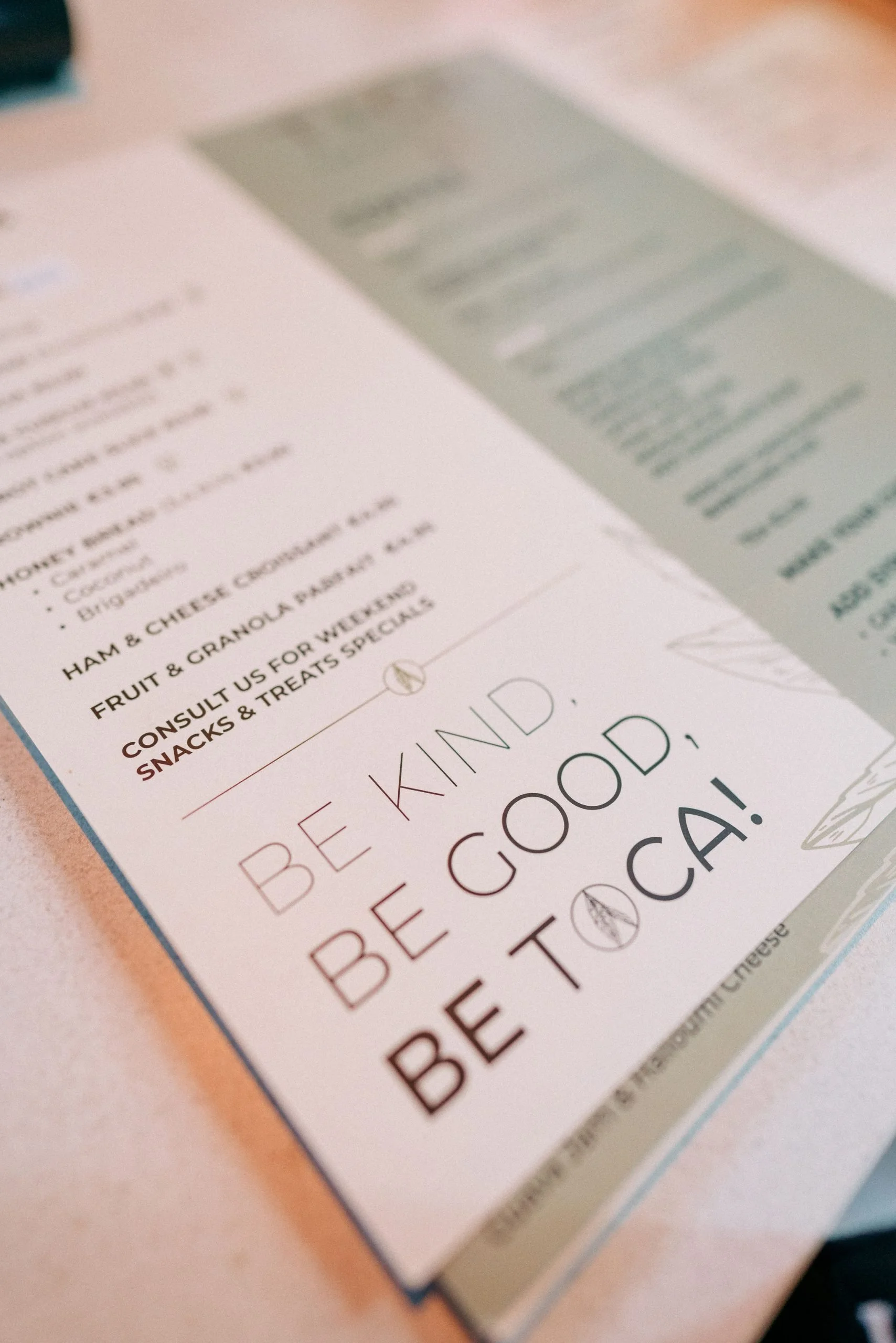 Close-up of a menu in Toca Tapioca with the Toca slogan - Be Kind, Be Good, Be Toca.