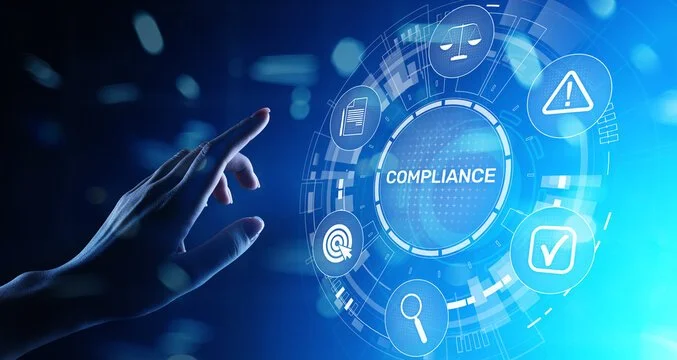 A person's hand reaching out to a digital interface displaying the word 'COMPLIANCE' surrounded by icons representing security, alert, checklist, magnifying glass, fingerprint, document, and target symbols, set against a blue digital background.