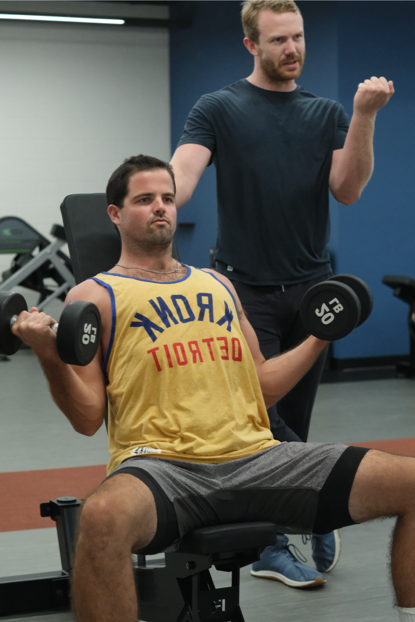 Julian demonstrates proper form with a client