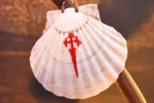 Scallop shell with the red Cross of St. James hanging from a pilgrim’s staff