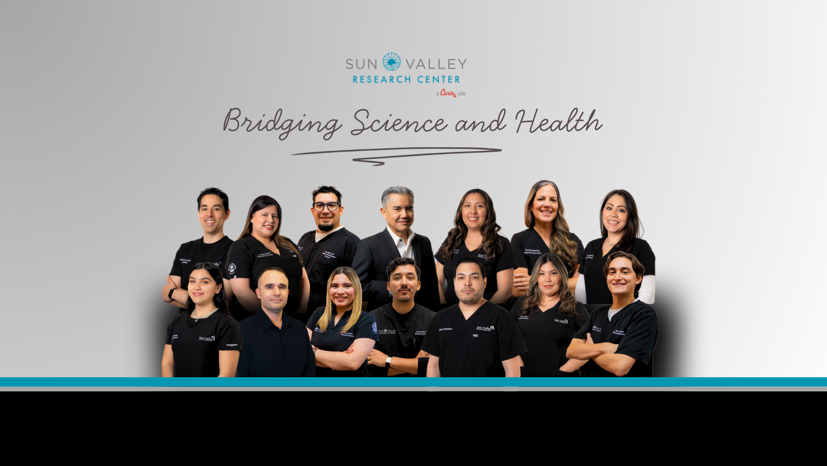 Group photo of diverse medical professionals wearing black shirts with the Sun Valley Research Center logo, standing against a gray background with the phrase 'Bridging Science and Health' above them.
