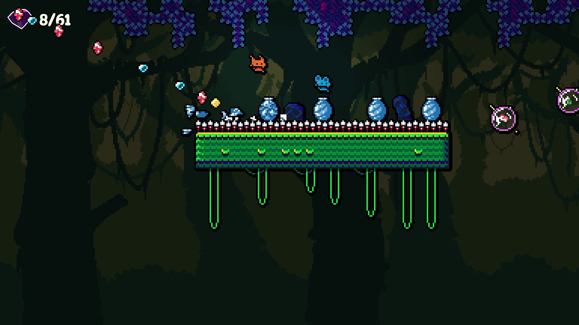 Pixel art scene from a video game set in a dark, forest environment. Features a small orange creature jumping over a row of spikes, coins, and split blue bottles. On the right, there are floating spherical objects with eyes, possibly enemies or inter