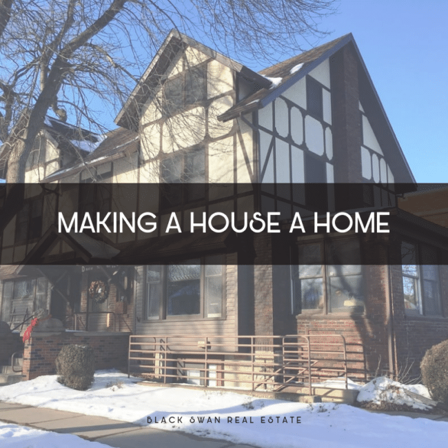 A photo of a house with a Tudor-style design, featuring half-timbering and stucco siding, with snow on the ground and a clear blue sky in the background.