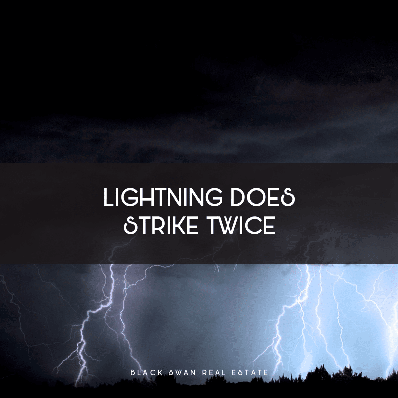Dark stormy sky with lightning strikes over a landscape with trees, captioned 'Lightning does strike twice' from Black Swan Real Estate.