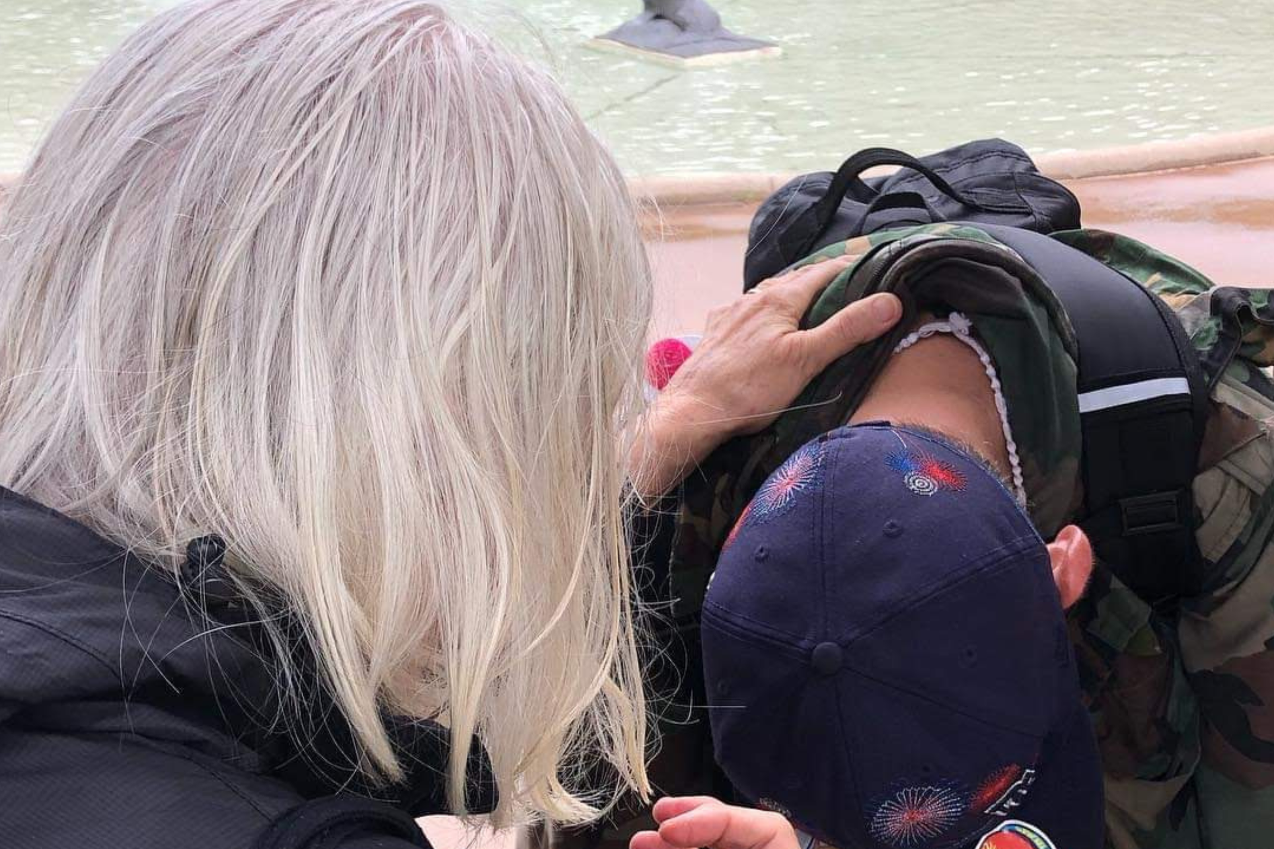 woman praying at a Lisa's House outreach event for a homeless man