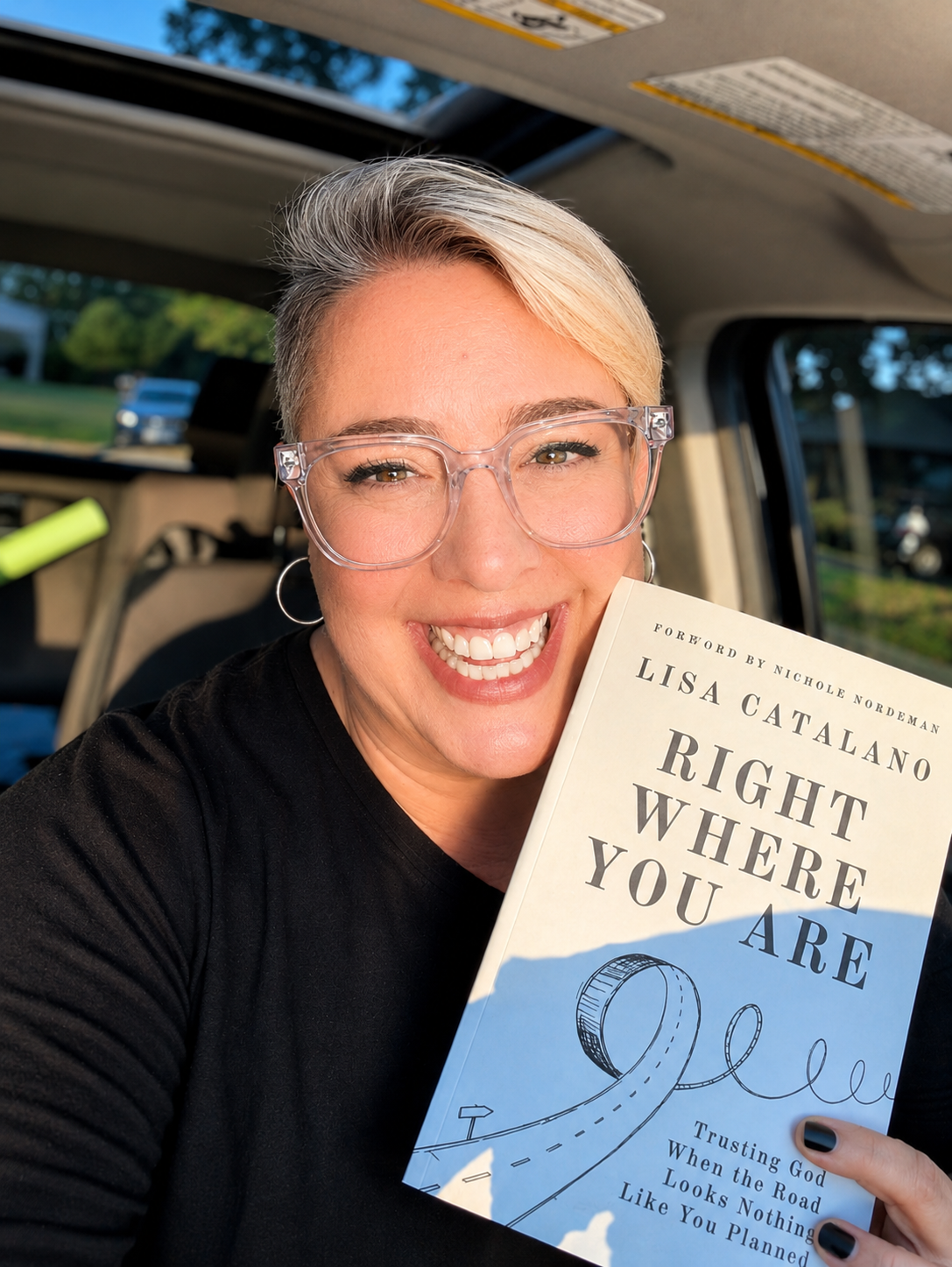 Lisa Catalano, Christian author and speaker, holding her book Right Where You Are: Trusting God When the Road Looks Nothing Like You Planned.