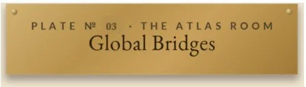 Gold plaque with black text reading 'Plate No 03 - The Atlas Room - Global Bridges'.