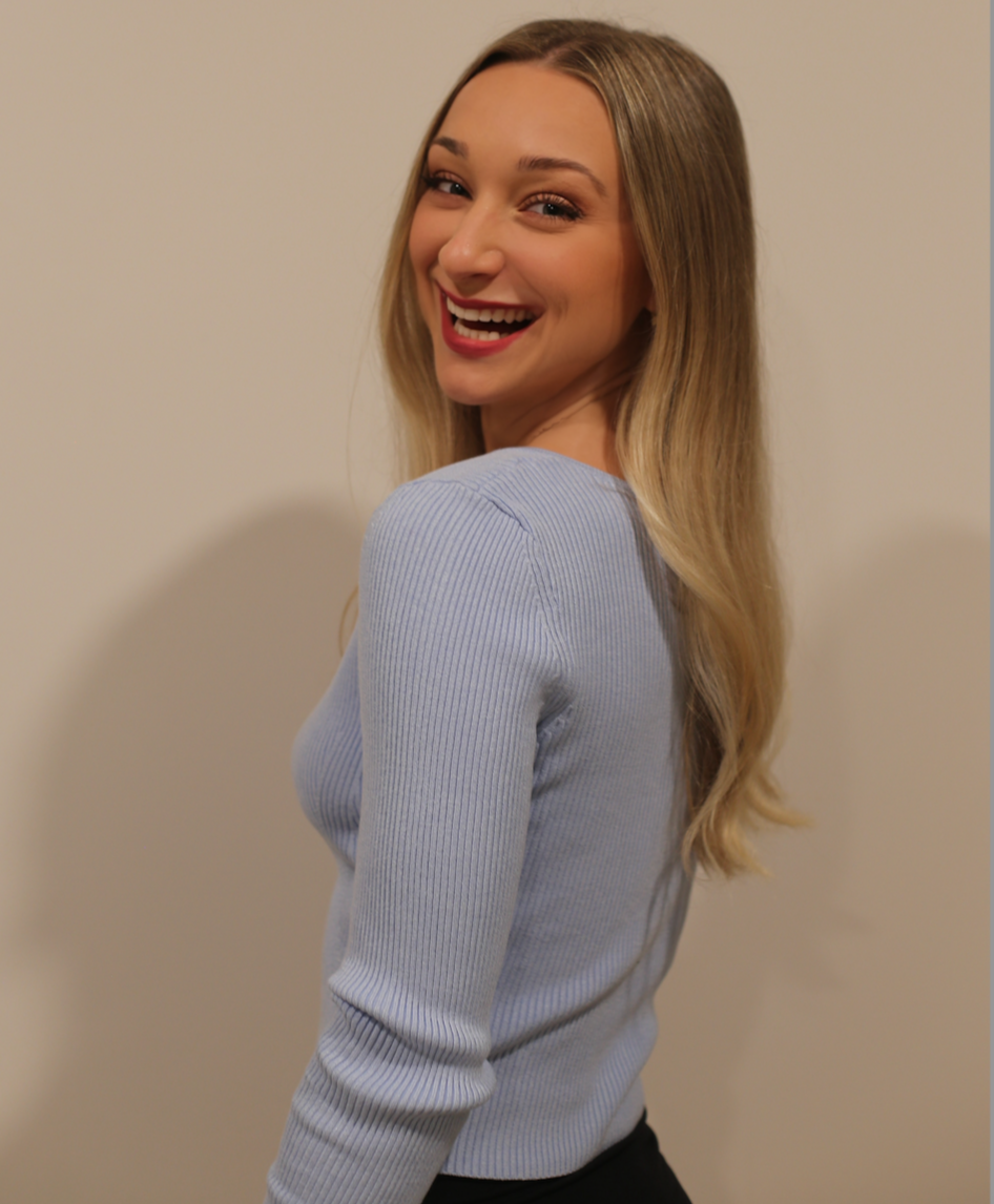 Kaley Dewey MS, RDN, CDN. Registered Dietitian. Eating disorder, gut health, and GI nutrition specialist. A young woman with long blonde hair, smiling and looking over her shoulder. Buffalo's #1 eating disorder dietitian.
