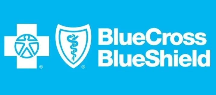 BlueCross BlueShield logo with a medical cross, shield, and caduceus symbol on a blue background.