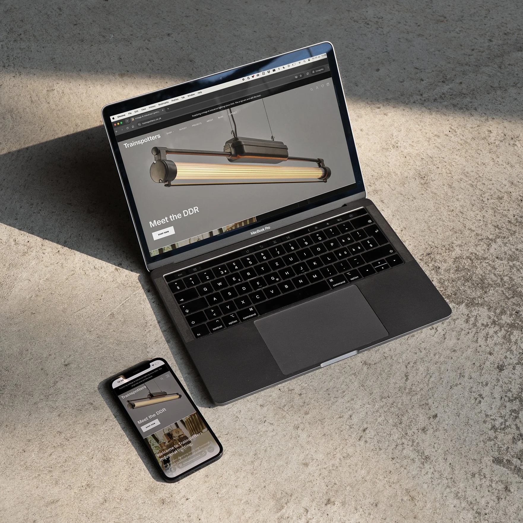 Trainspotters Ltd website on mobile and desktop on concrete floor