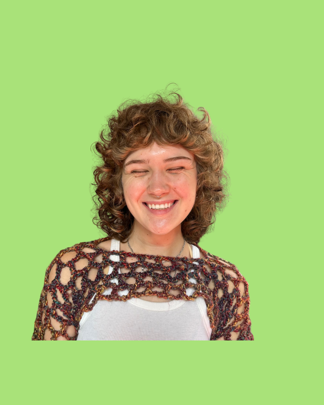 Young woman with curly hair smiling against a bright green background.