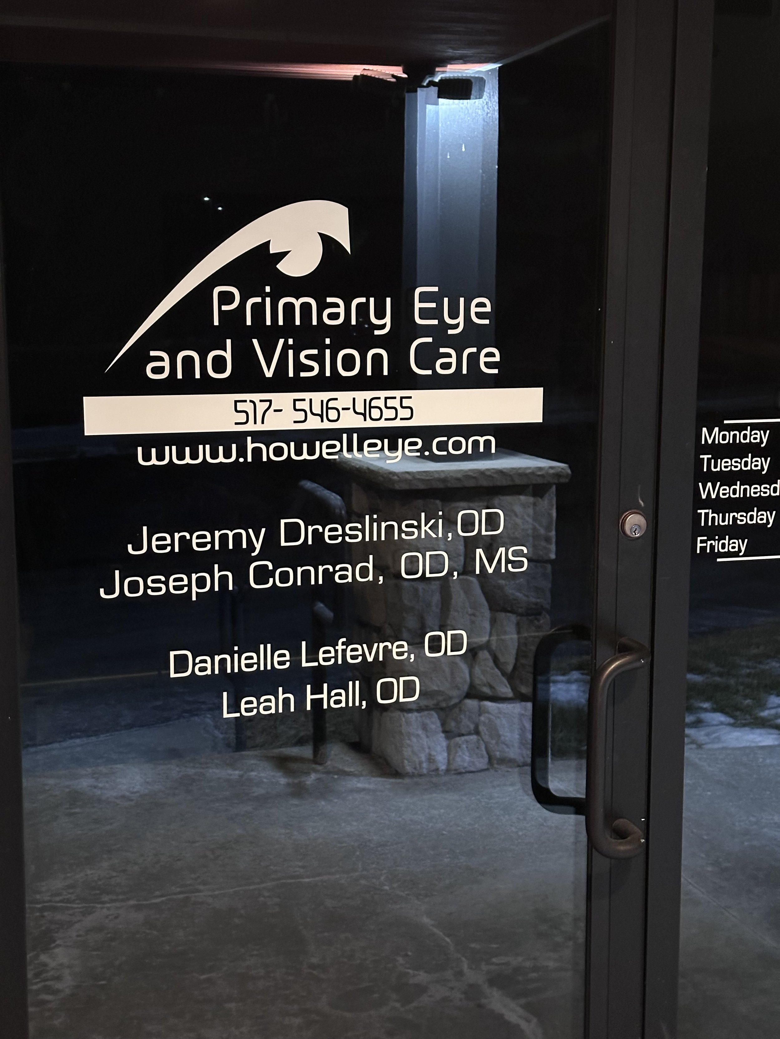 Sign for Primary Eye and Vision Care practice displaying contact number, website, and staff names.