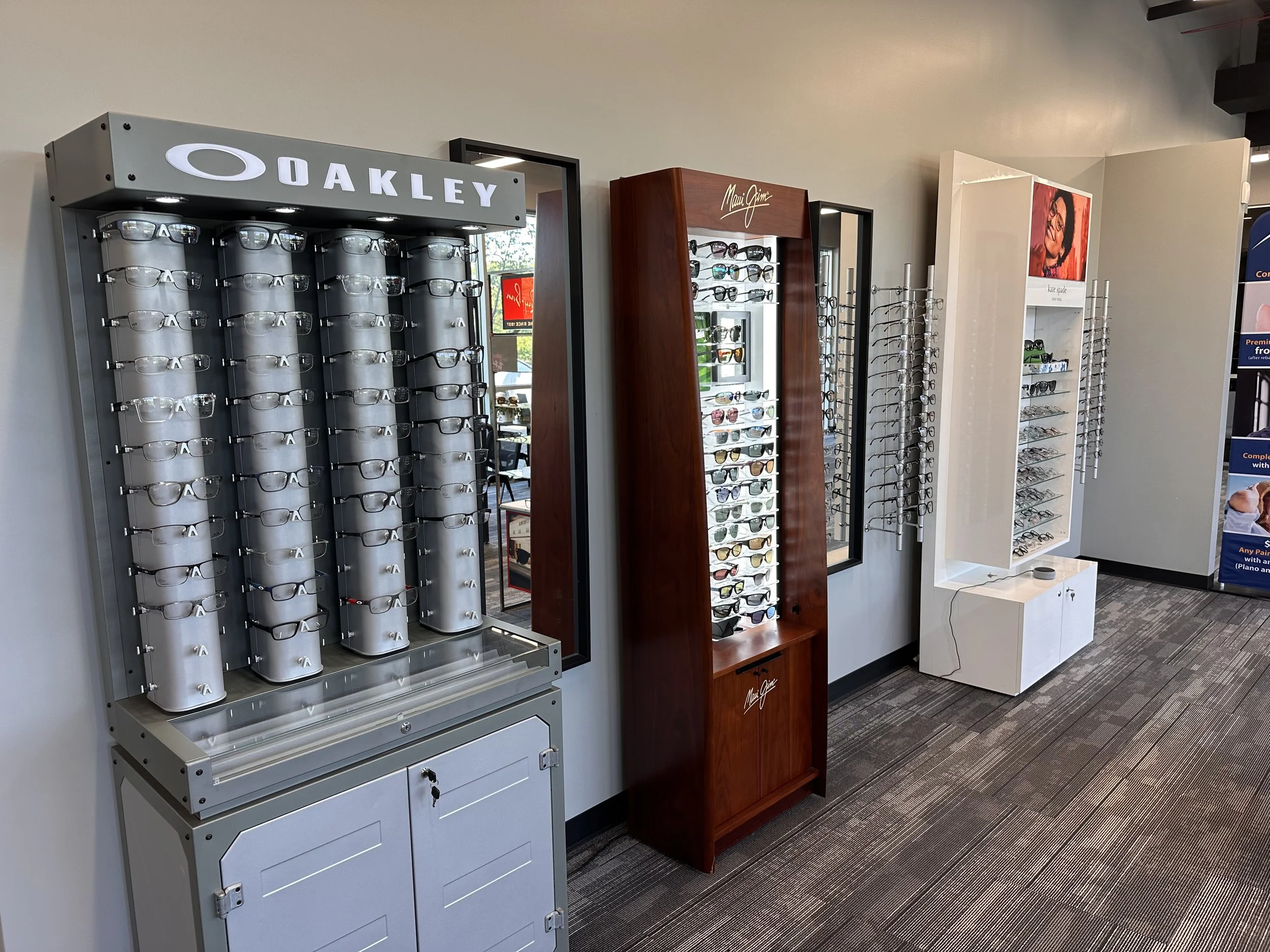 Eyewear display cases on the wall with various glasses and sunglasses in a retail store