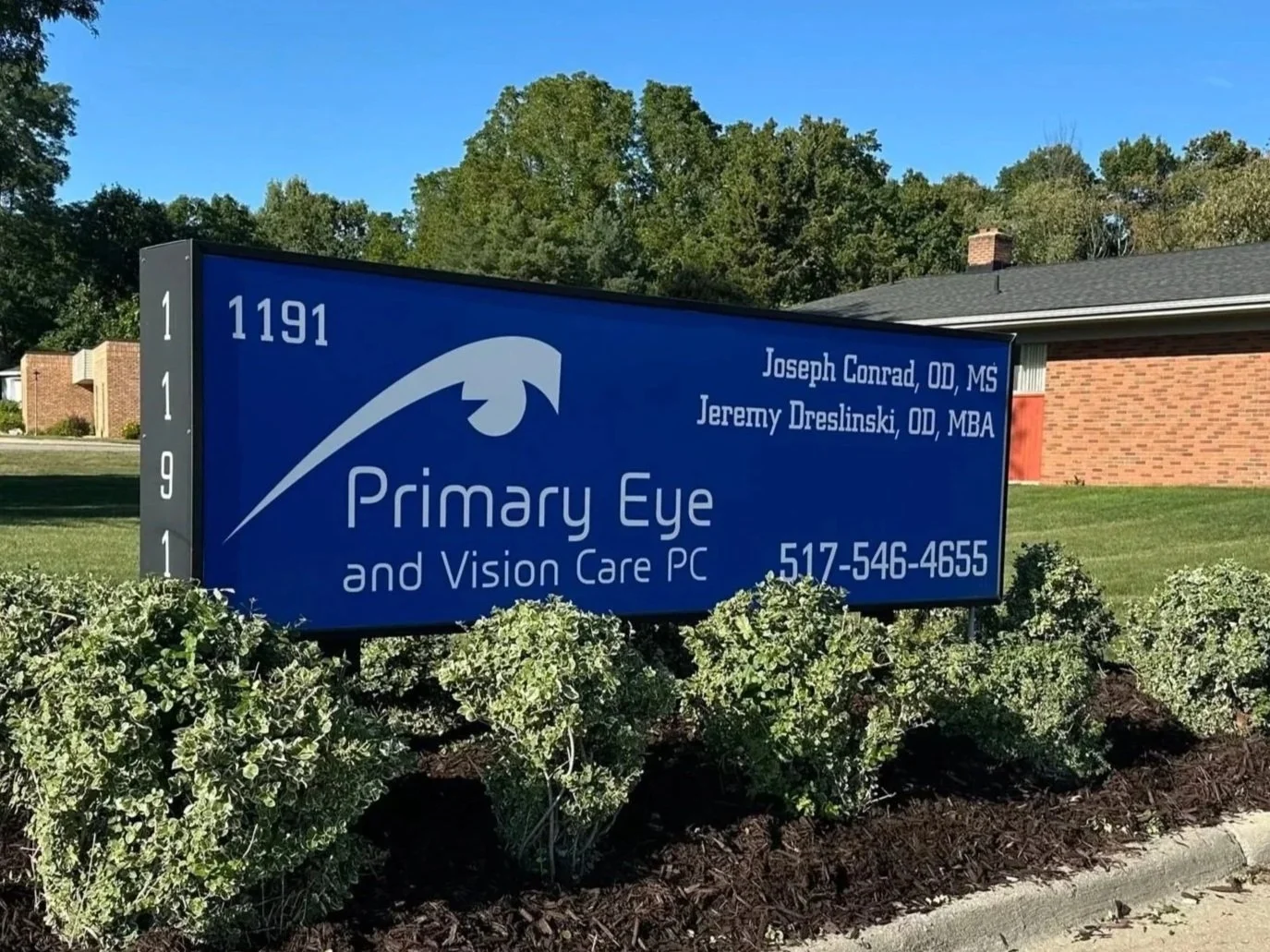 Sign for Primary Eye and Vision Care PC with contact number, located at 1191. The sign includes the names Joseph Conrad and Jeremy Dreslinski, and features a logo of an eye.