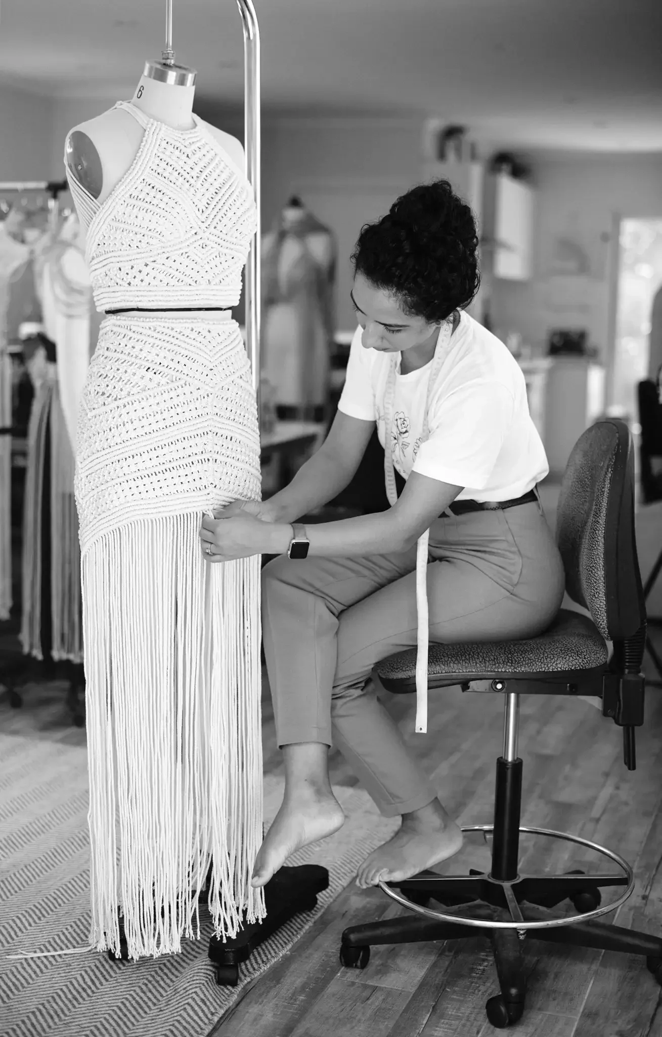 Fashion designer, Denisse M Vera, working on a macrame wedding dress in her studio.