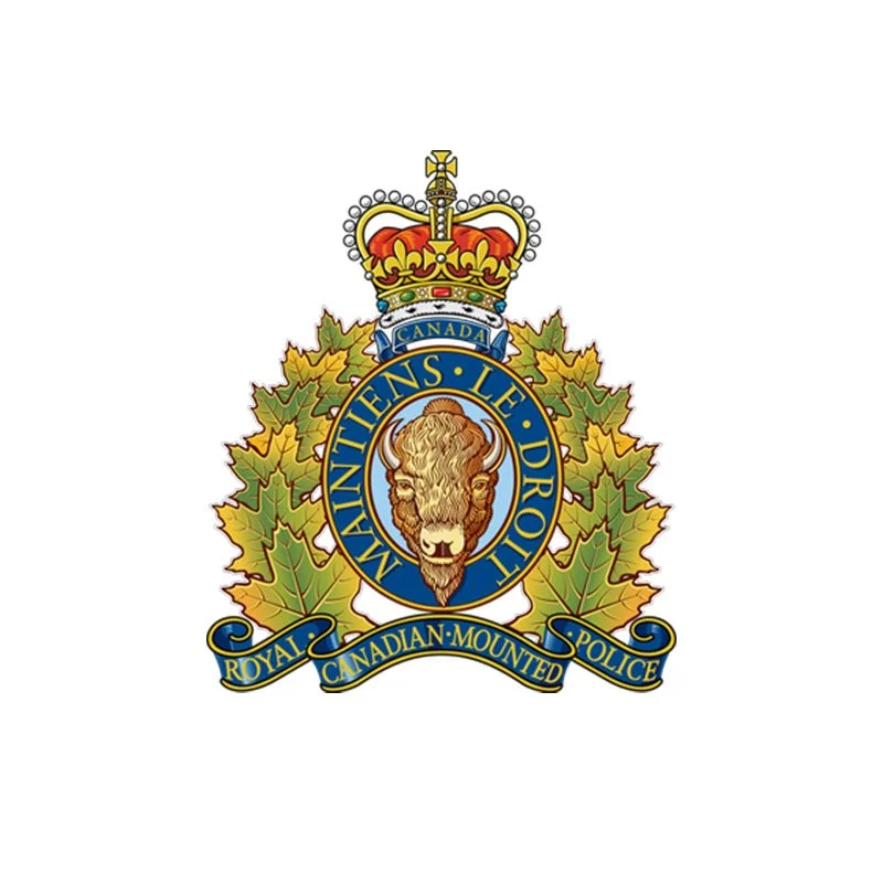 Emblem of the Royal Canadian Mounted Police featuring a lion's head, a crown, autumn leaves, and a banner with the words "Royal Canadian Mounted Police."