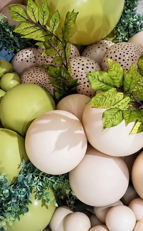 Decorative grapes and leaves in shades of green, beige, and cream.