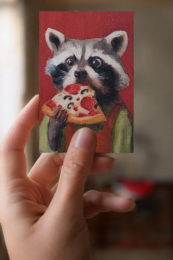 ATC racoon with pizza painting holded in hand.jpg