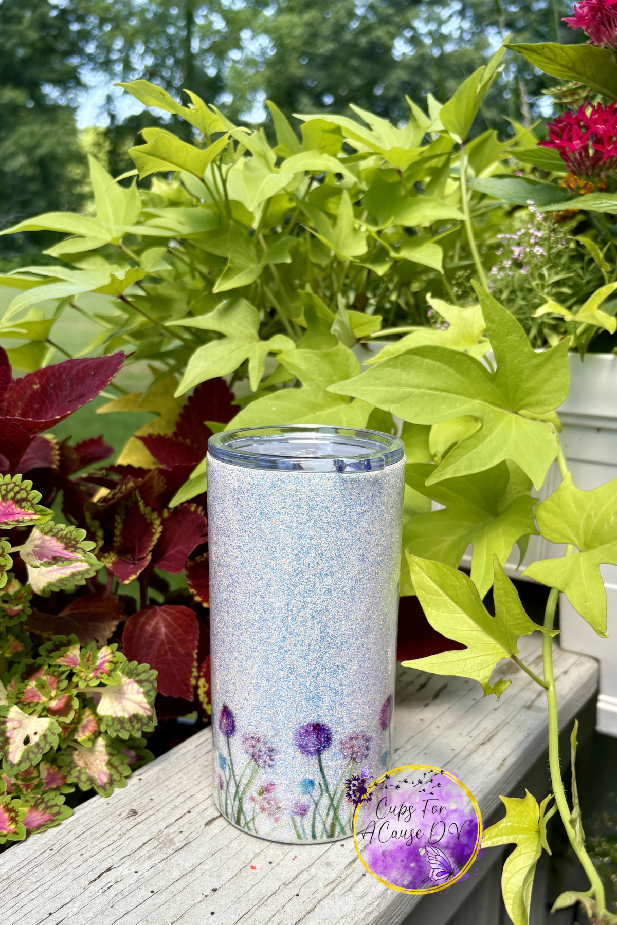 Purple dandelion (allium) on white glitter