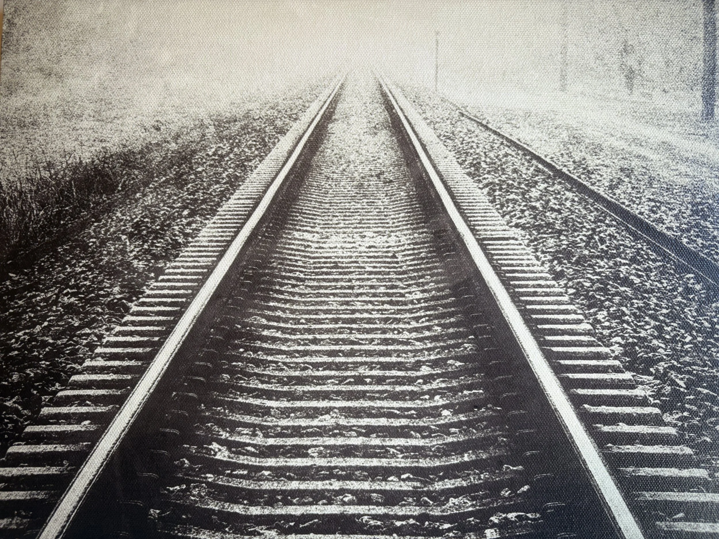 Black and white photograph of railroad tracks extending into the distance, Photography Show featured in Fusion Fine Art in Parkville, MO.