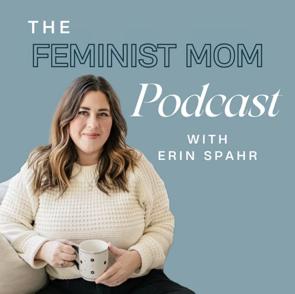 A woman with long wavy brown hair, wearing a cream sweater, sitting on a couch, holding a mug, smiling. Background includes text: 'The Feminist Mom Podcast with Erin Spahr' on a muted blue background.