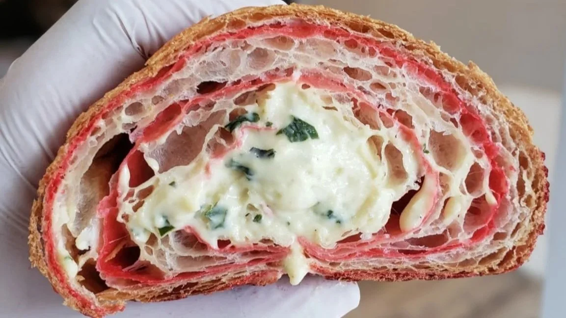 Swirled bi color baked pastry croissant with layers of strawberries and cream, basil garnish freshly baked in myrtle beach, south carolina