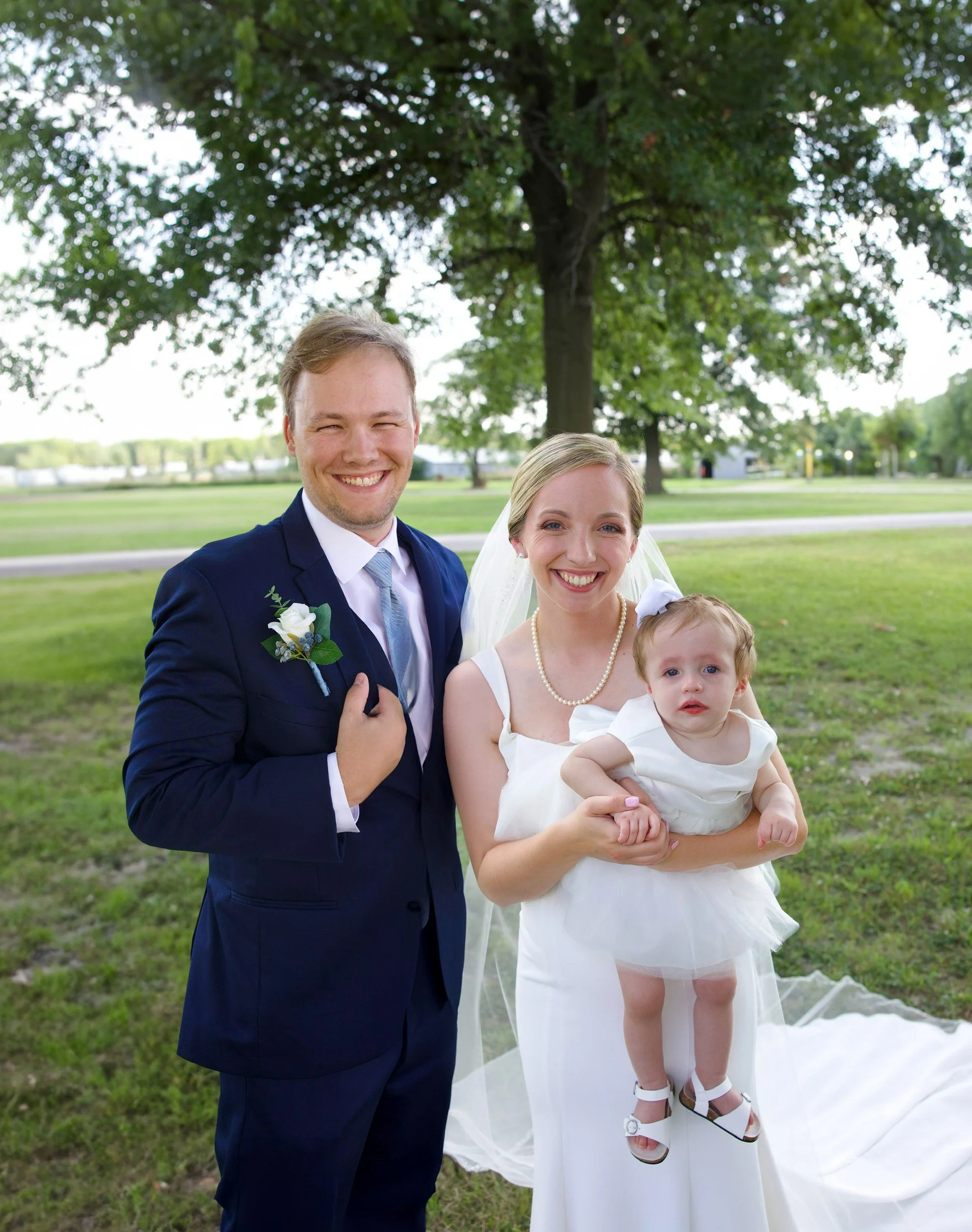 Created a family portrait by skillfully combining separate images of the bride, groom, and child into one cohesive, natural-looking photo.