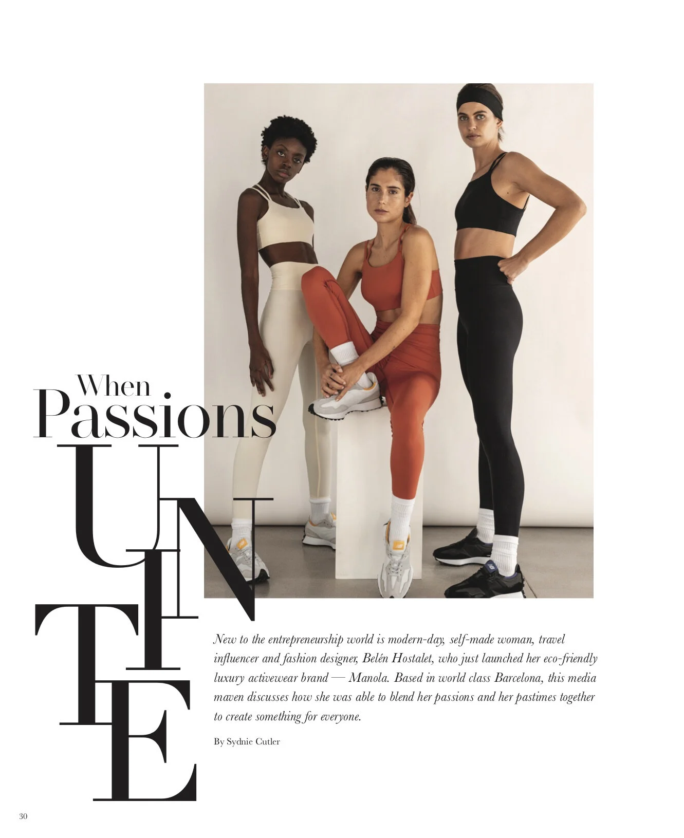 Three women wearing athletic wear, standing against a plain white background, with one sitting on a white block and the other two standing on either side of her.
