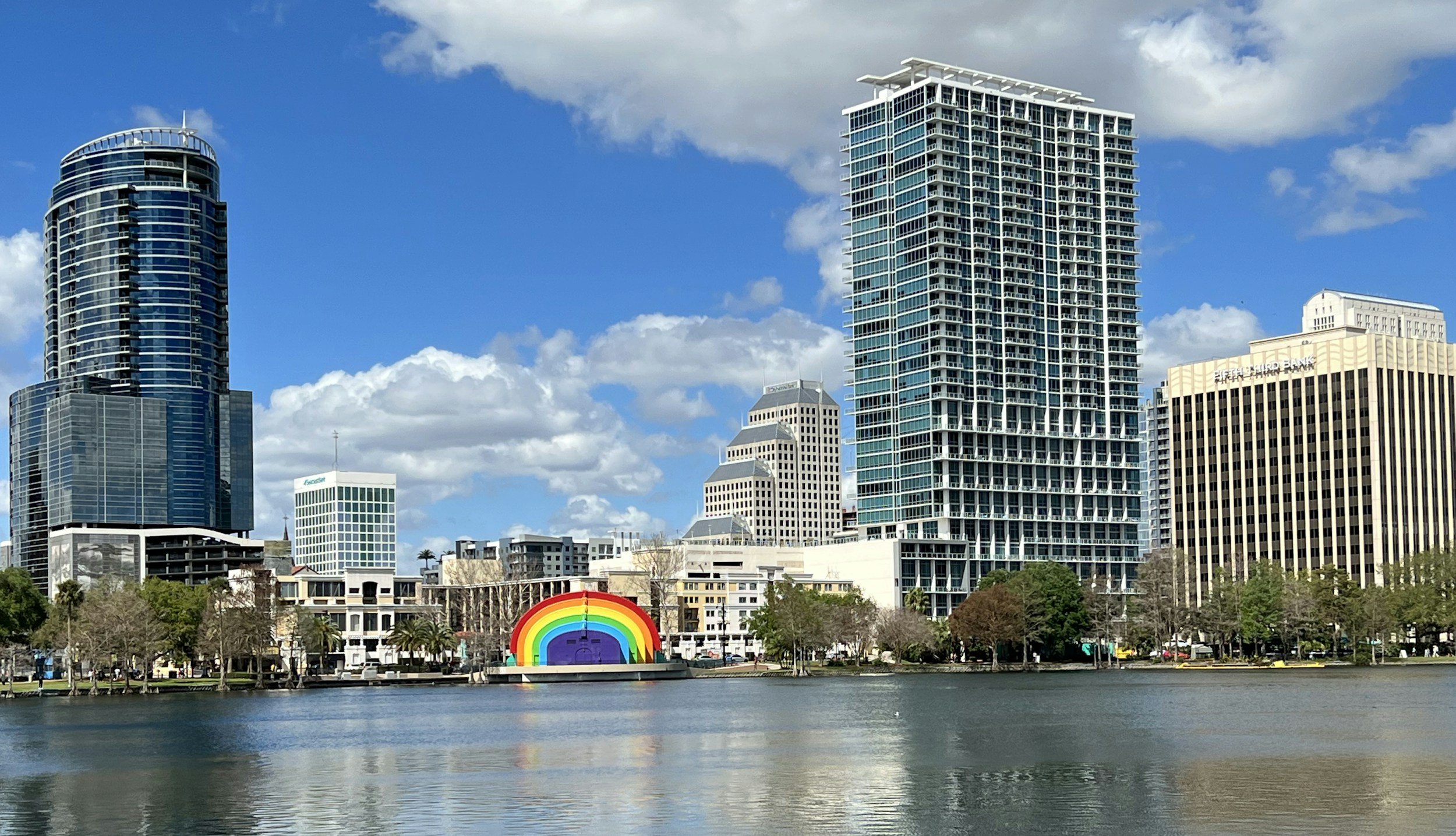 The iconic rainbow-striped bandshell at Lake Eola Park, an Orlando landmark reflecting LGBTQ+ pride and community resilience