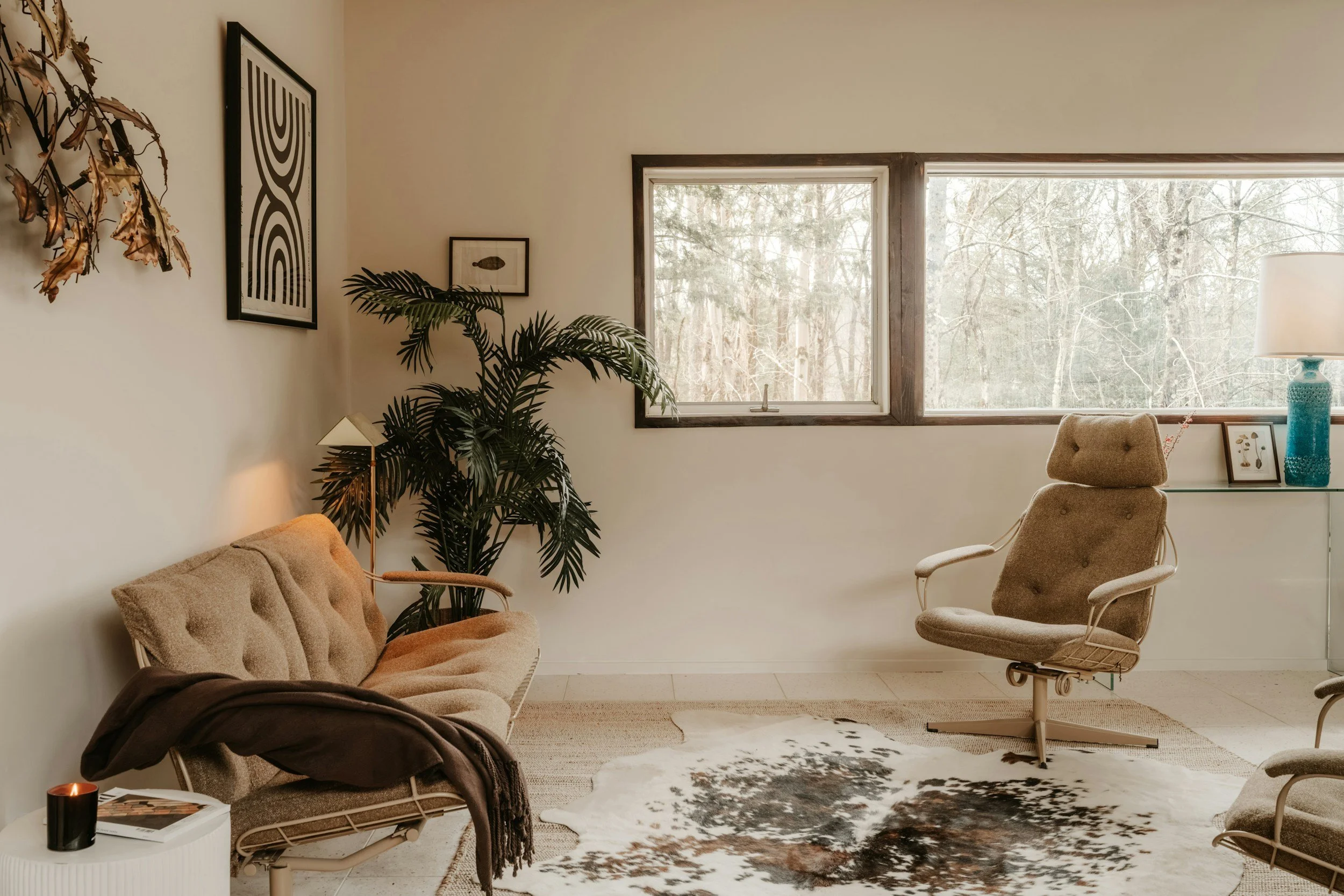 Sunlit therapy room with cozy seating and plants representing an integrative, affirming clinical approach