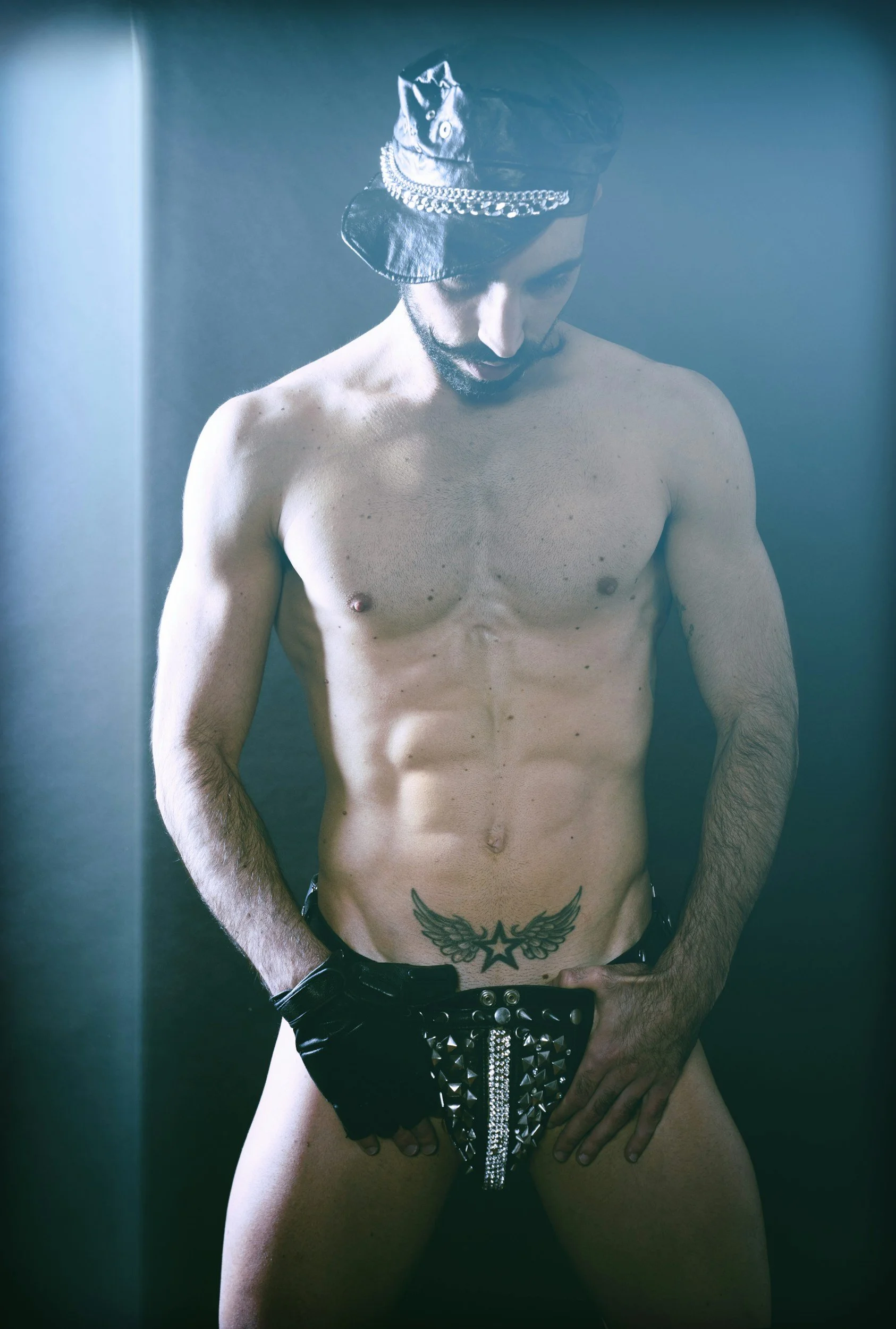 Man wearing a black leather harness for kink and BDSM-affirming sex therapy.
