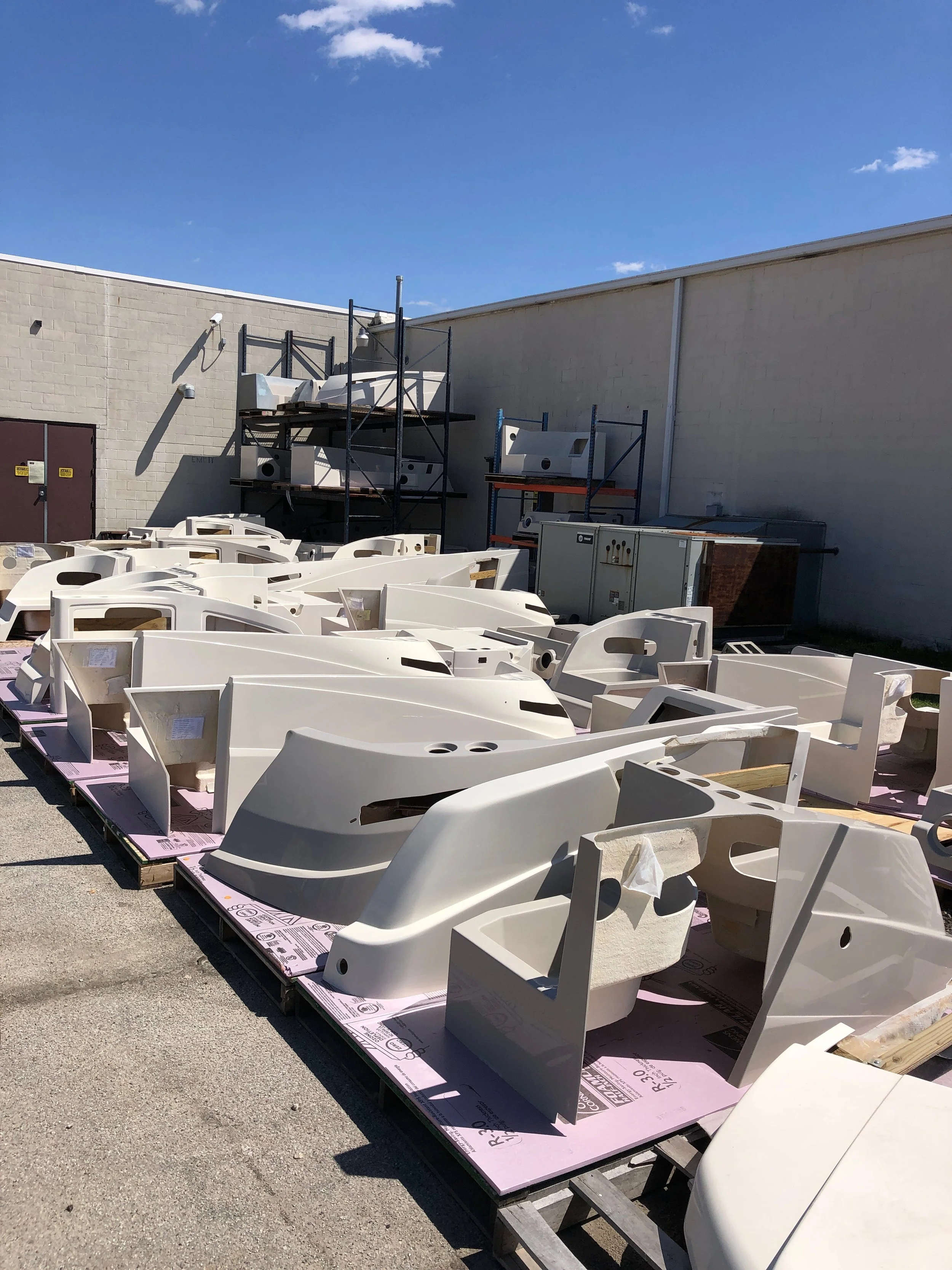 fiberglass boat hulls, some partially assembled, we paint marine parts, boat parts, boat hulls, boat siding, and more in Akron, Indiana.