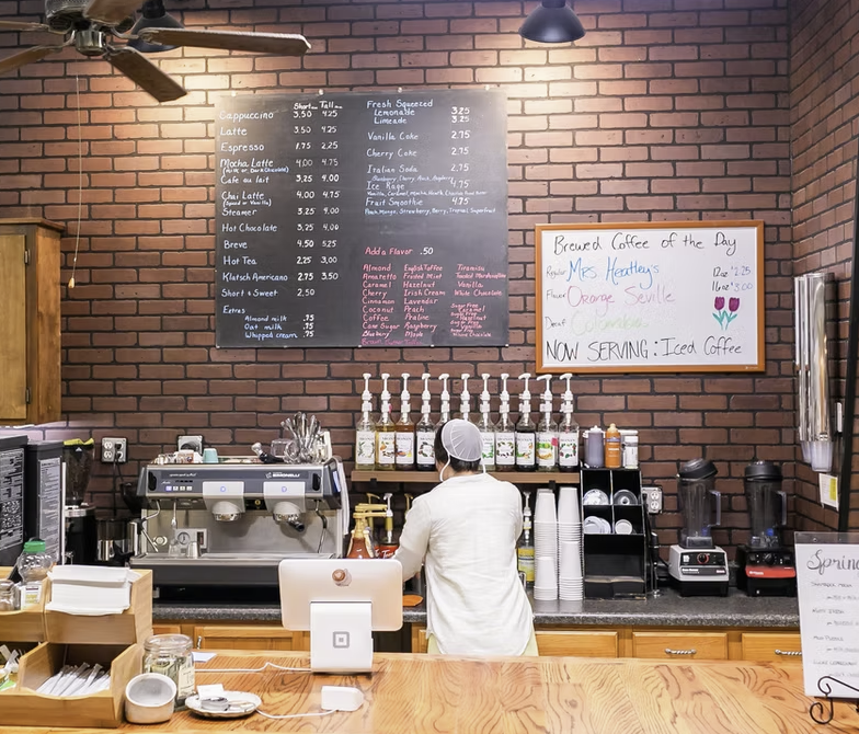 Customers ordering handcrafted coffee at the Kaffee Klatsch coffee counter.