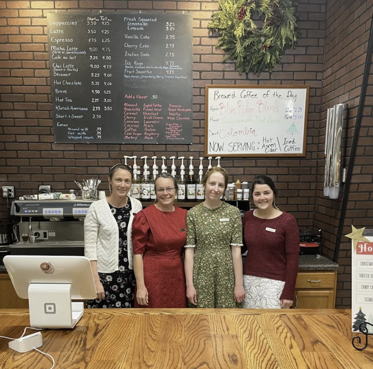 The Kaffee Klatsch team serving customers behind the coffee bar.