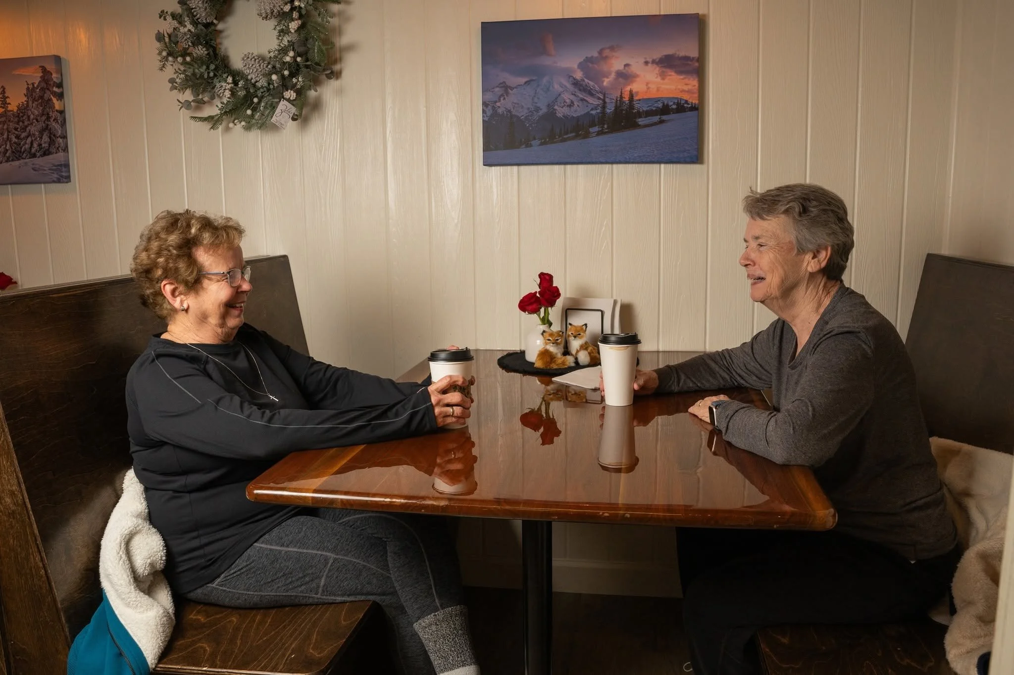 Guests enjoying conversation inside the welcoming Kaffee Klatsch coffee shop.