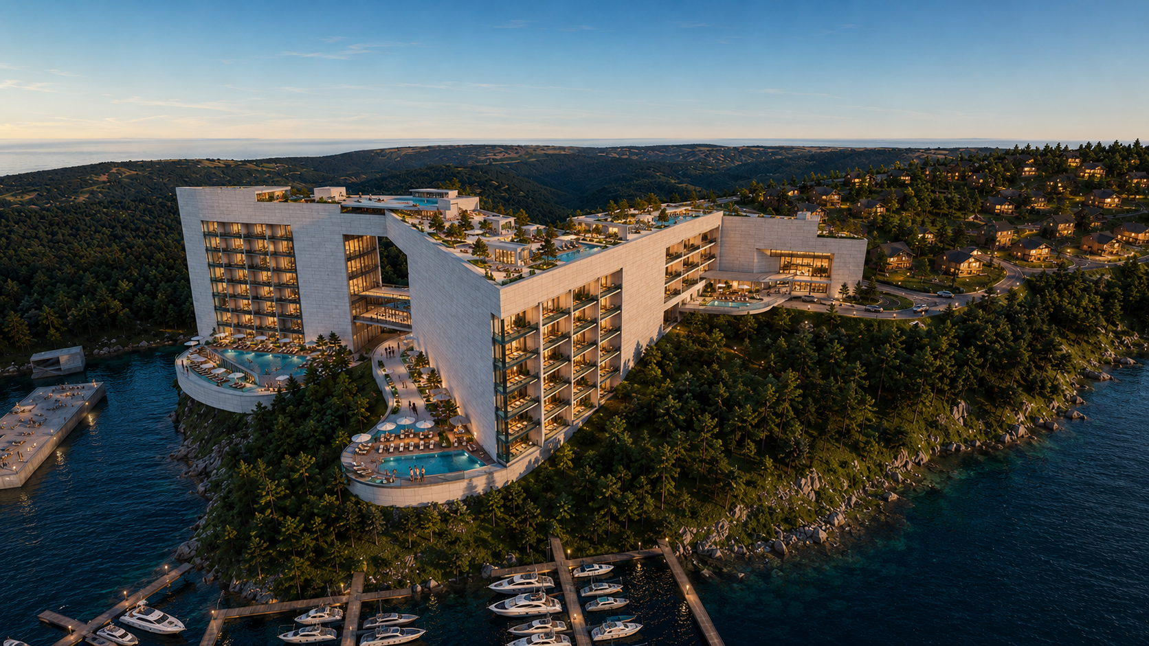 Aerial view of a modern hotel with swimming pools on a hillside overlooking a body of water and a residential neighborhood.