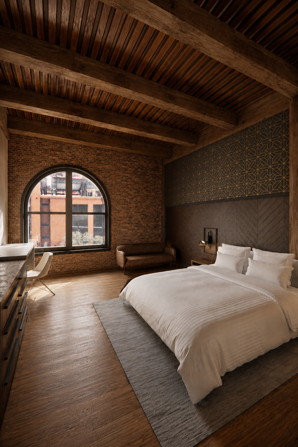 A stylish bedroom with a exposed wooden ceiling, brick wall, large arched window, and modern decor including a white bed, leather couch, and a desk with a chair.