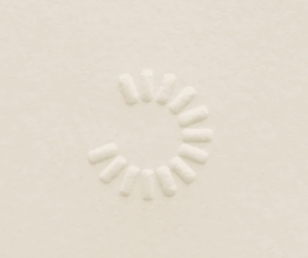 White capsule pills arranged in a circle on a white background.