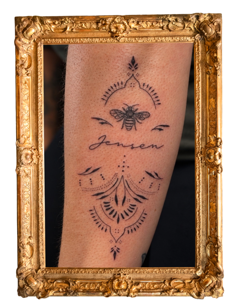 Custom ornamental fine line tattoo with delicate symmetrical linework and decorative details on the lower leg, by Wander + Lost Ink in Bellingham, Washington.