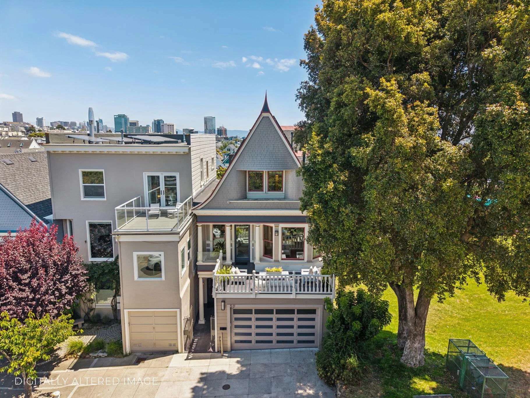 A view of a multi-story house with a Victorian style roof, a small balcony, and a garage, surrounded by trees and overlooking a city skyline in the background.