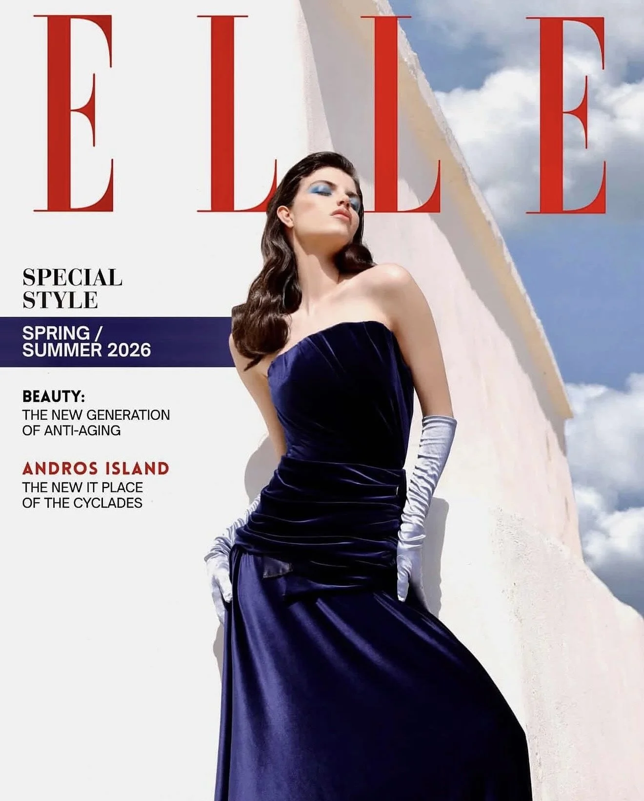 Cover of Elle magazine featuring a woman in a blue velvet gown and silver gloves, standing outdoors against a white wall and blue sky, promoting Spring/Summer 2026 fashion with headlines about anti-aging beauty and Andros Island.