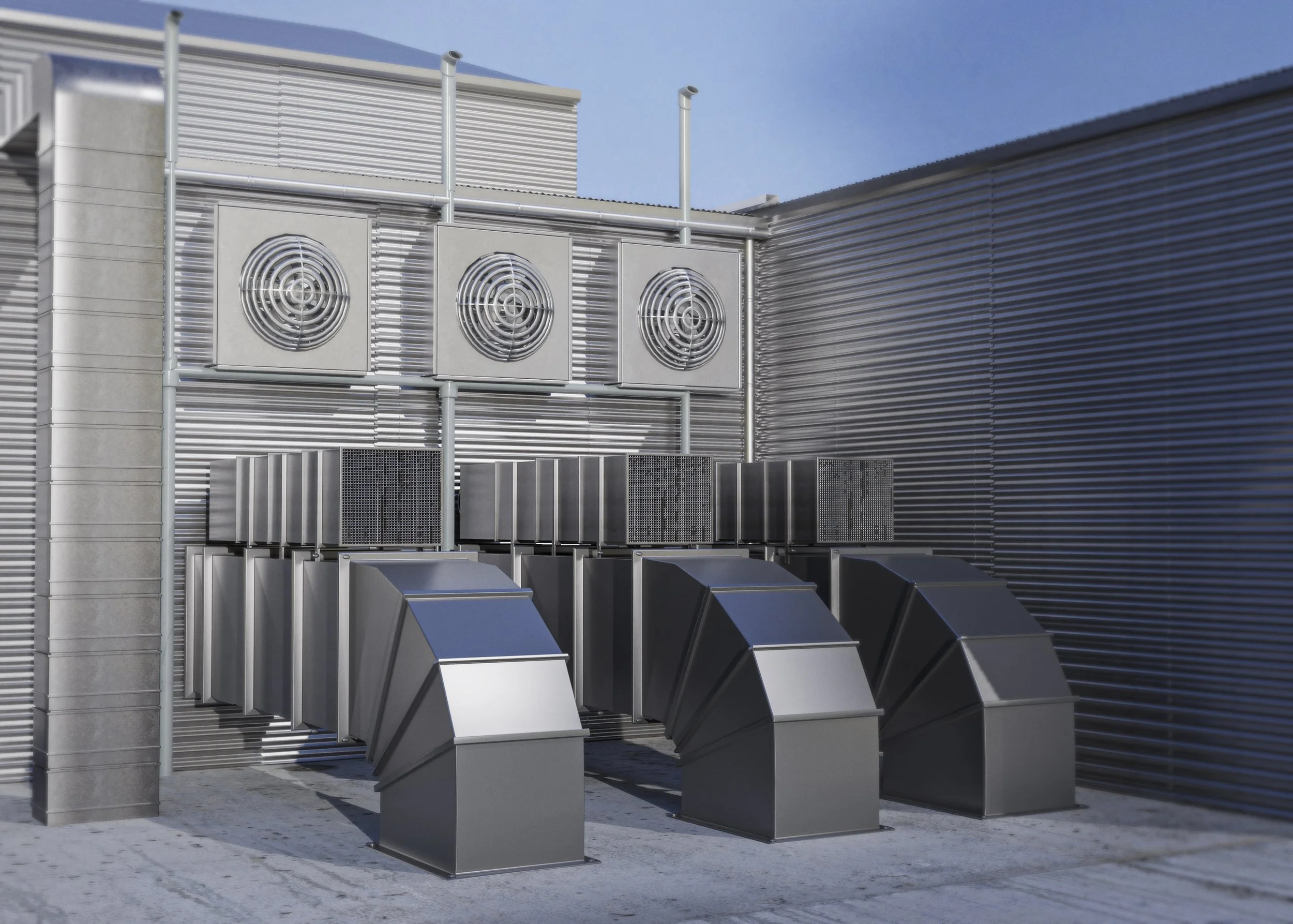 Exterior of a modern building with metallic vent and grille units on the wall, and several angular metal exhaust vents on the ground, under a clear blue sky.