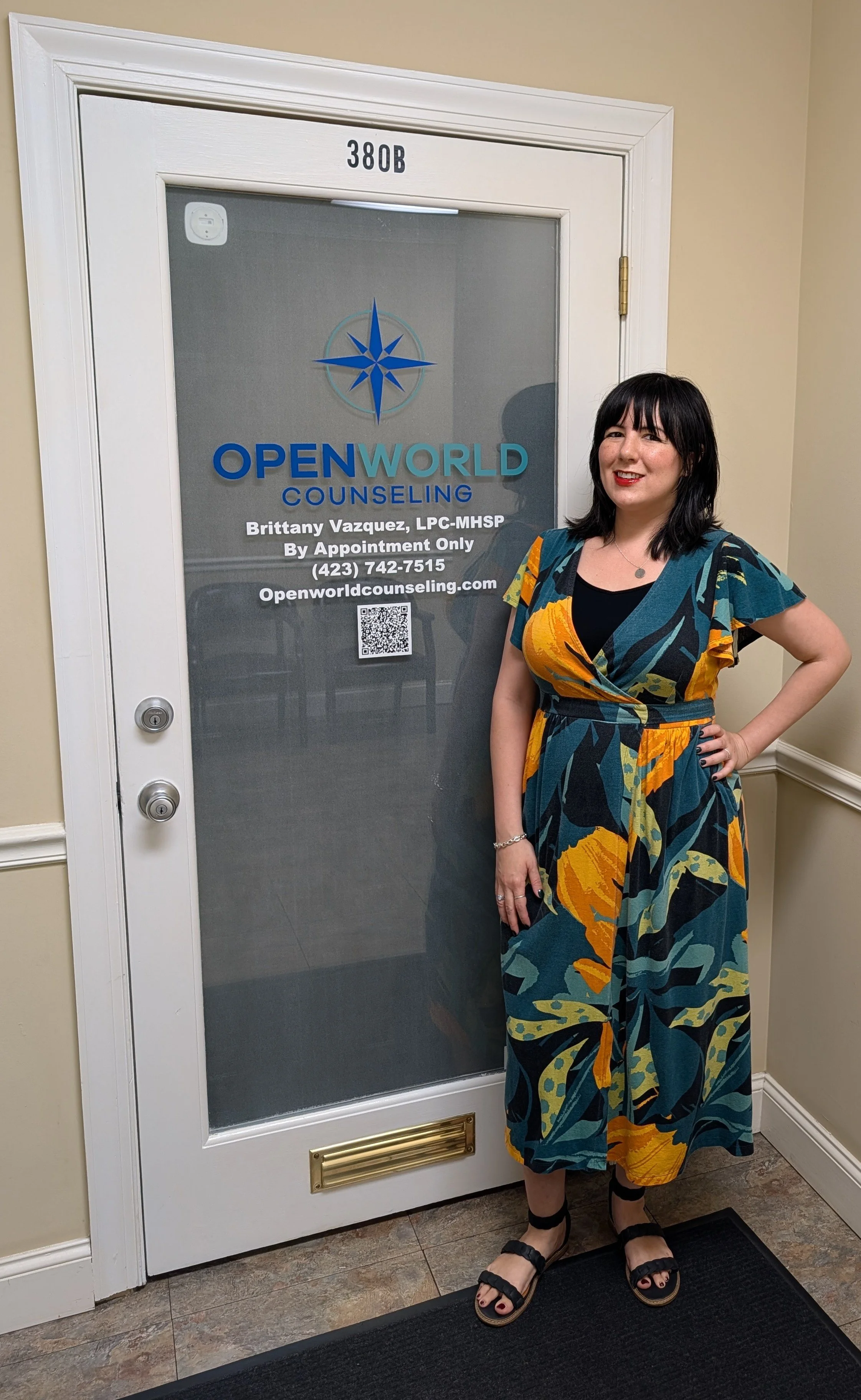 Picture of Brittany Vazquez standing in front of the Openworld Counseling office