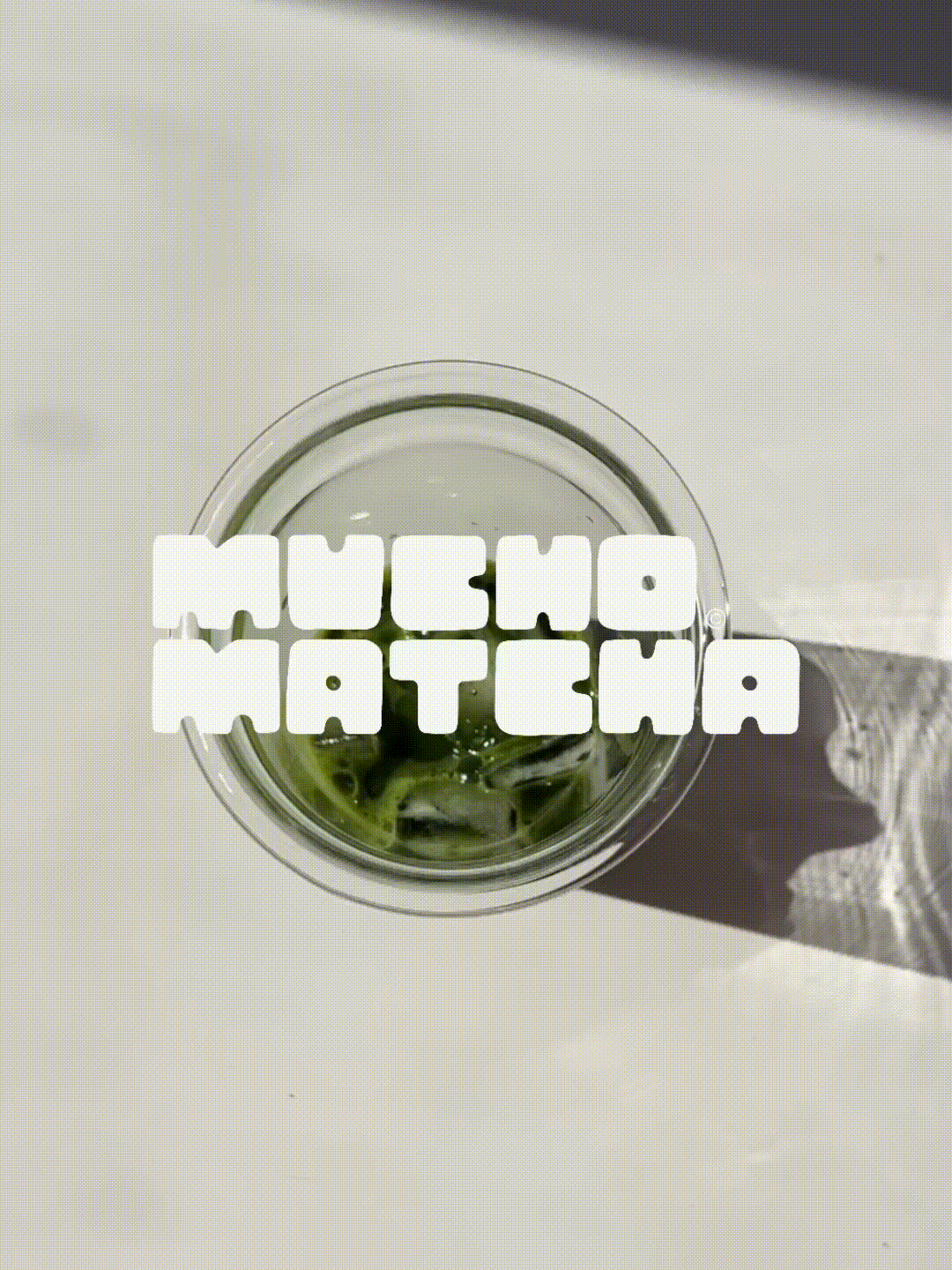 A top view of a glass with a beverage containing ice and lime slices, on a white surface, with a piece of lace fabric partially over the glass, and text overlay that reads 'Moscow Mules'.