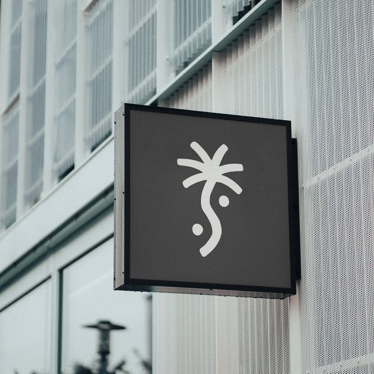 Modern outdoor sign with abstract design on a city building.