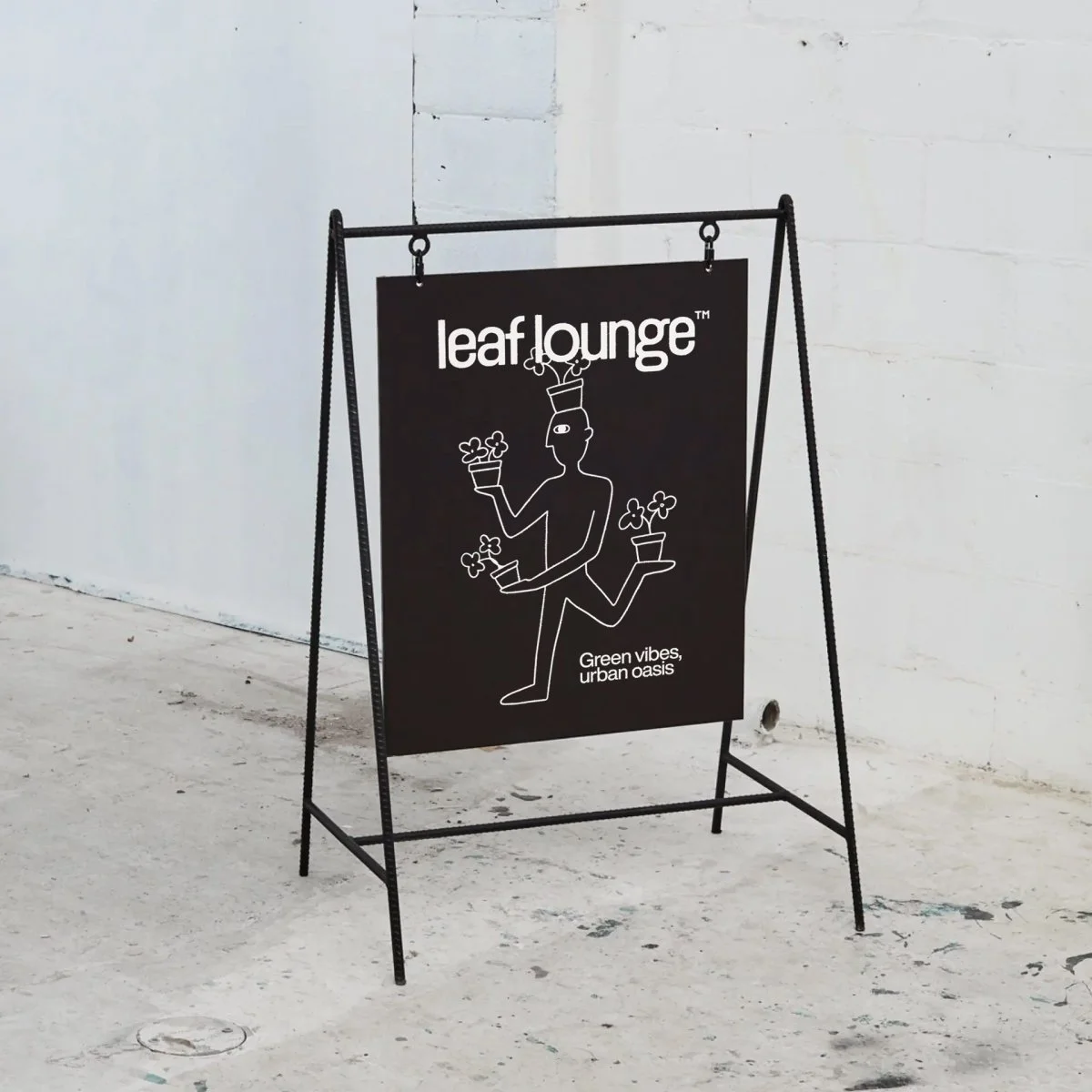 Black sidewalk signboard for leaf lounge, featuring a minimalist line drawing of a person with three arms holding potted plants, with additional potted plants below. Text reads "leaf lounge" and "Green vibes, urban oasis".