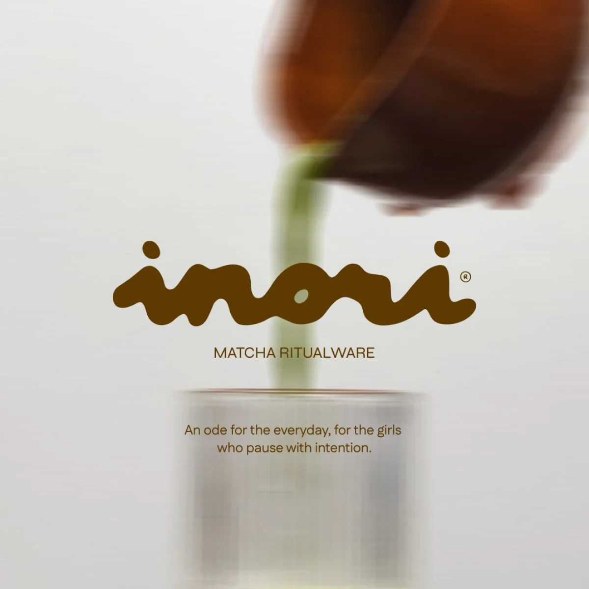 A hand pouring green matcha powder into a glass with the logo 'inoi' and the text 'MATCHA RITUALWARE' below it, with a tagline: 'An ode for the everyday, for the girls who pause with intention.'